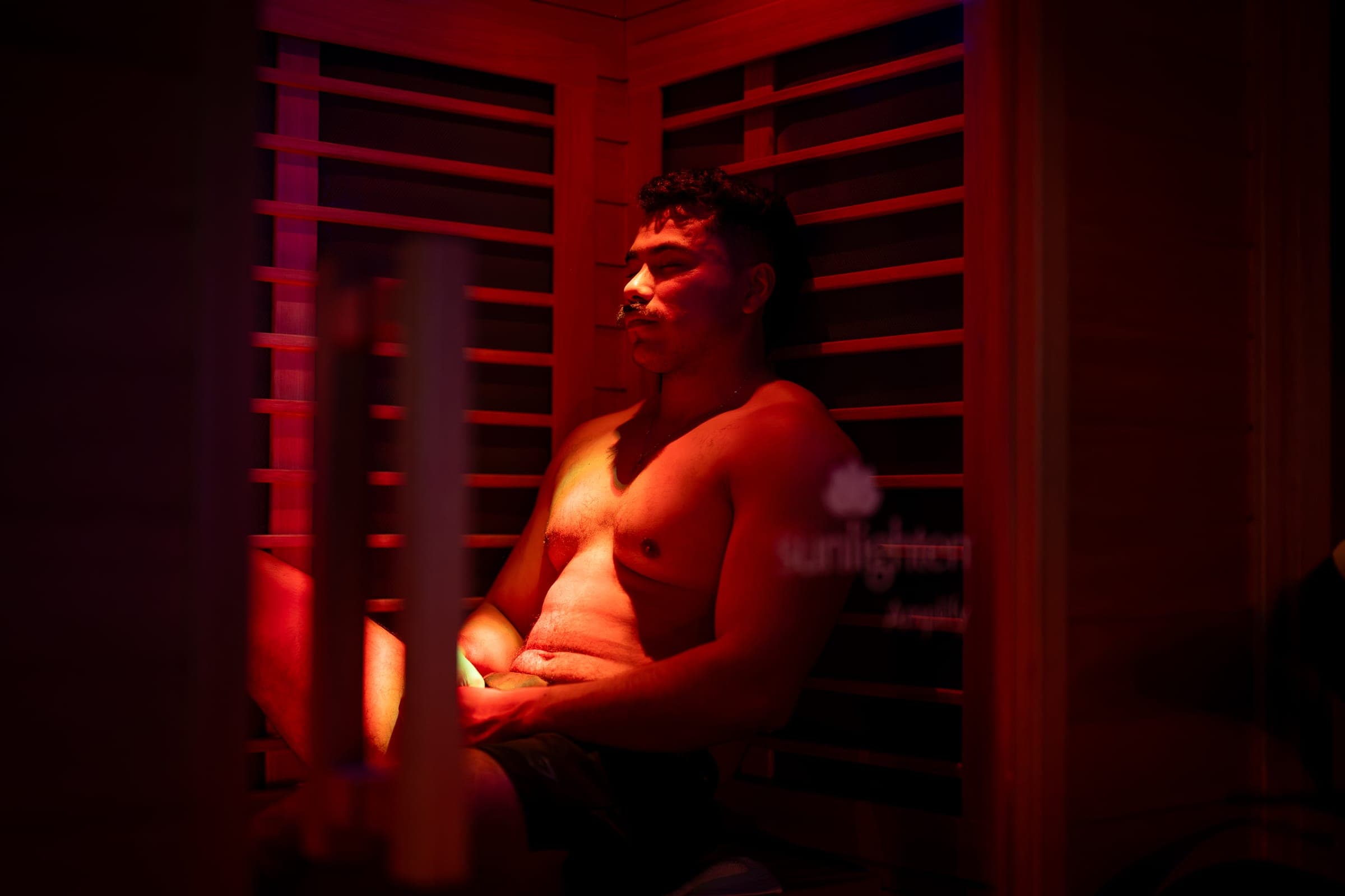 Contrast therapy at CBR: a guest sits back in the red-lit infrared sauna between plunges