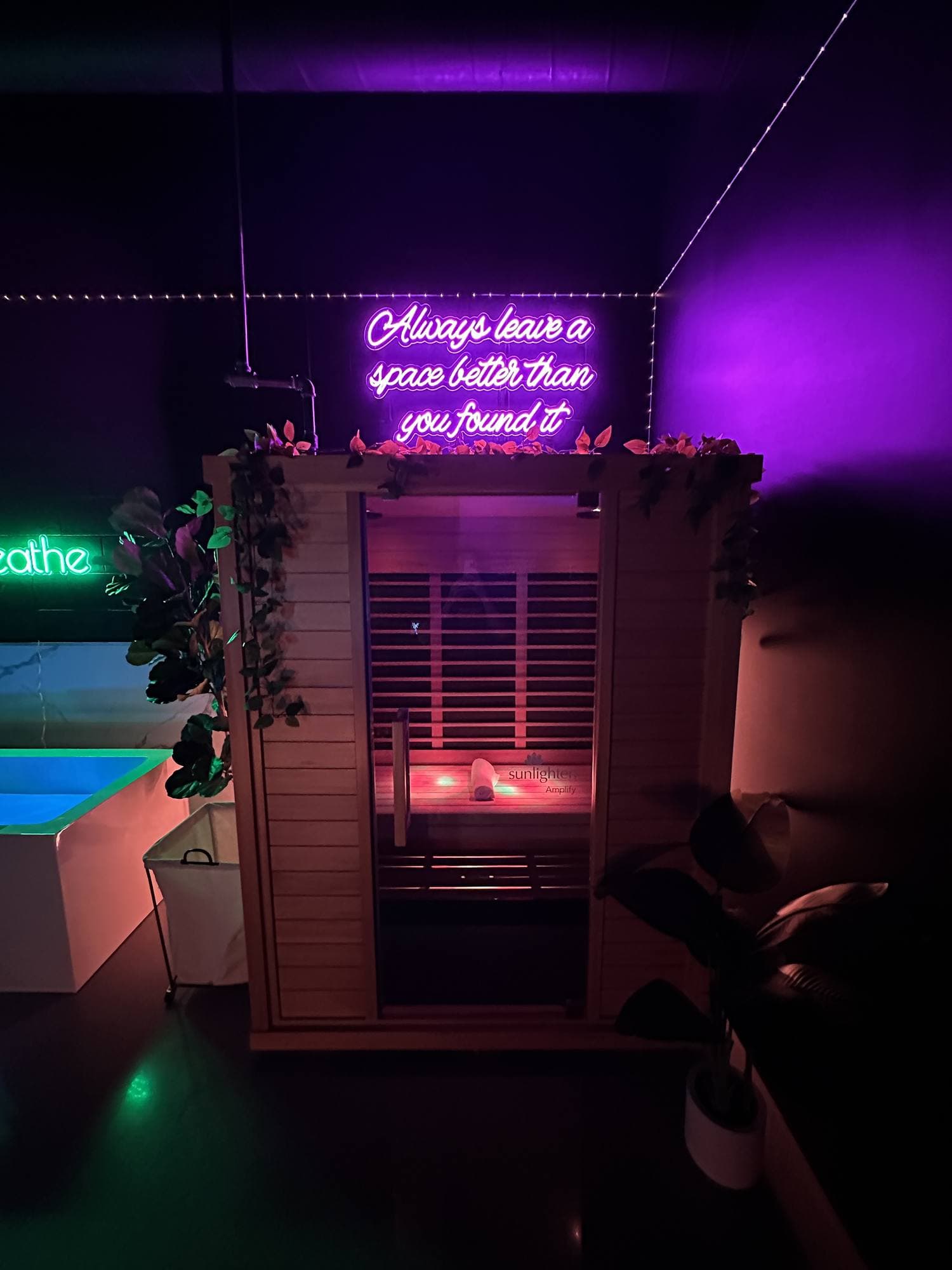 A Temecula sauna under a pink neon sign that reads: Always leave a space better than you found it